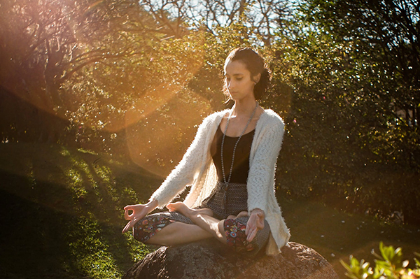 Meditation and Kratom image of a woman in a meditation pose in the woods