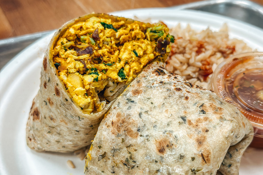 A delicious kratom-infused breakfast burrito with salsa and rice on the side.