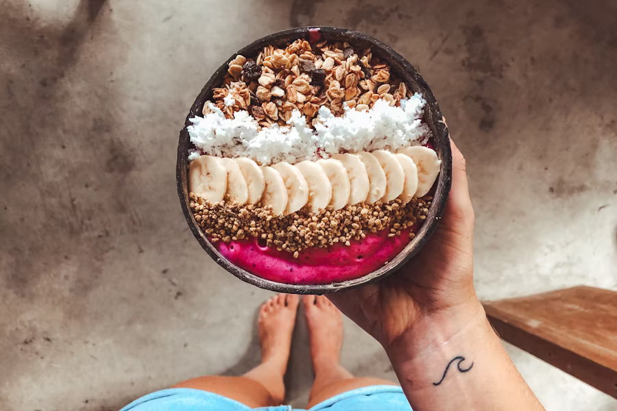 A woman holding a kratom-infused smoothie bowl